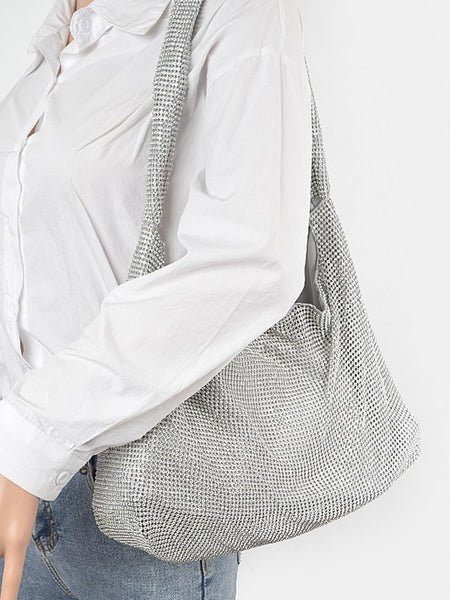 Artini Accessories Quilted Shoulder bag in silver metallic worn on shoulder with white shirt and jeans
