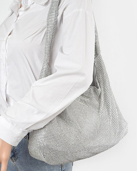 Artini Accessories Quilted Shoulder bag in silver metallic worn on shoulder with white shirt and jeans