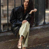 Rag Company bow ballerina flats for women in metallic shade worn with light pants and black jacket