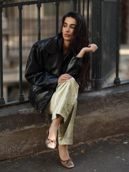 Rag Company bow ballerina flats for women in metallic shade worn with light pants and black jacket