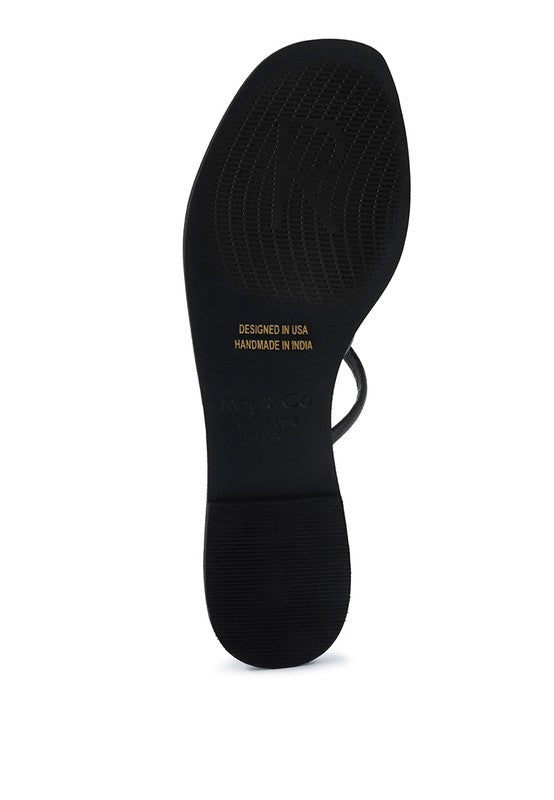 Black sole view of Babe Beachwear chic metallic flat slip-ons sandals with textured grip