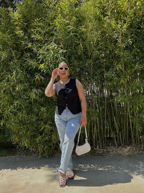 Woman wearing Babe Beachwear chic metallic flat slip-ons with light blue jeans and black sleeveless top