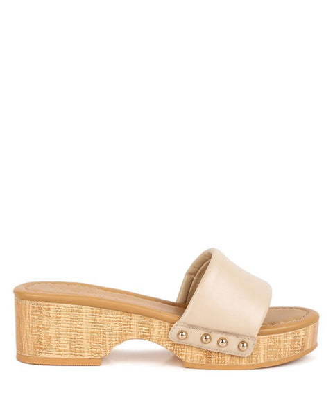 Rag Company beige clog wooden sandals with studded straps and textured wooden platform heel