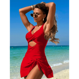 Beach Babes red sexy cutout swim dress worn by woman at the beach with blue sea background