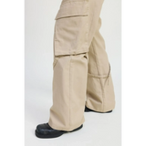 Beige relaxed cargo pants for women by Emory Park styled with black shoes