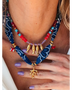 Trendsi resort cruise statement coral necklace with red beads gold fish charms and blue fabric detailing