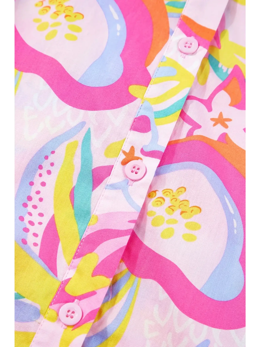 Close-up of pink floral ruffle sleeve mini dress resort pattern with buttons by Babe Beachwear