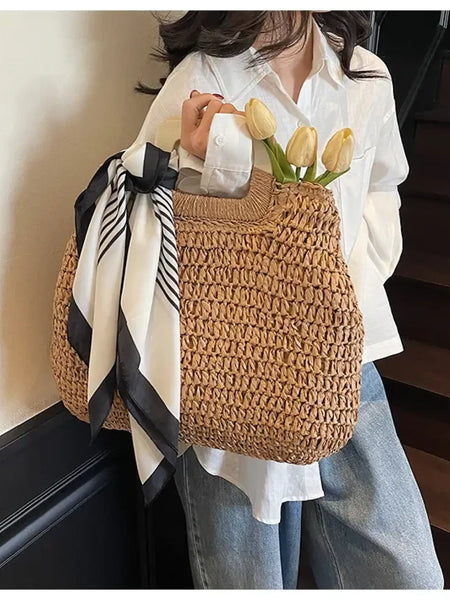 woven straw bag with black and white scarf and tulips perfect resort wear accessories for women