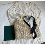woven bag with black and white scarf on cream dress as resort wear accessories for women