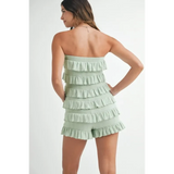 Trendsi light green ruffled tube romper with tiered ruffle details worn by a woman from back