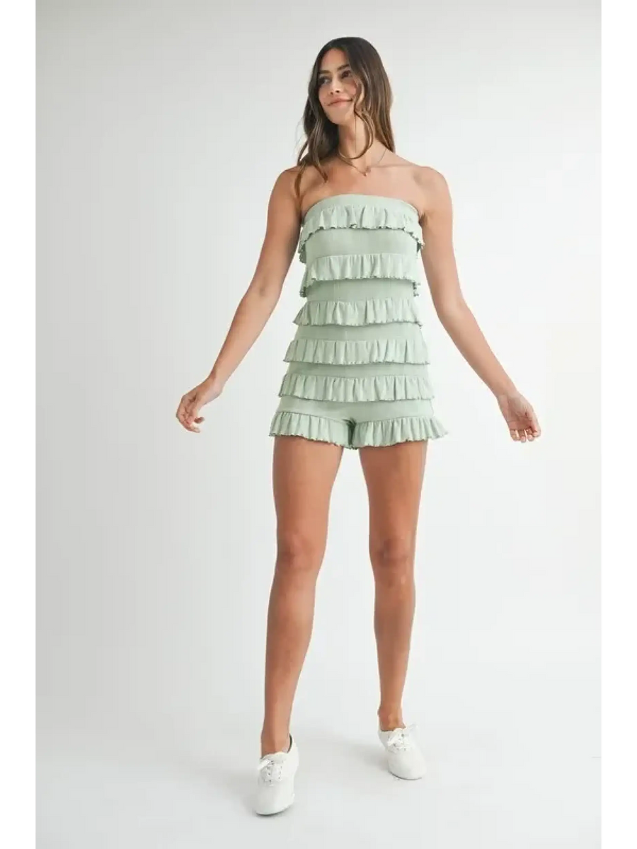 Trendsi green ruffled tube romper with layered frills worn by model with white sneakers