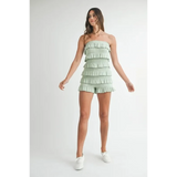 Trendsi green ruffled tube romper with layered frills worn by model with white sneakers