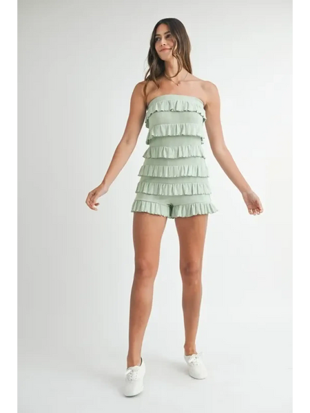 Trendsi green ruffled tube romper with layered frills worn by model with white sneakers