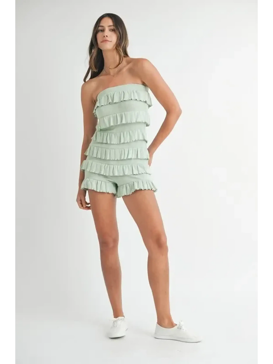 Trendsi light green ruffled tube romper worn by woman with white sneakers