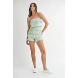 Trendsi light green ruffled tube romper worn by woman with white sneakers