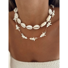 Seashell layered necklace for beach featuring white shell and starfish designs on a model's neck