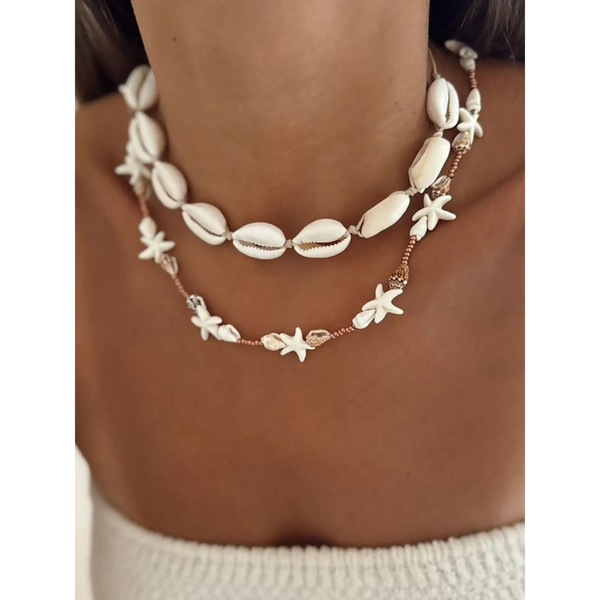 Seashell layered necklace for beach featuring white shell and starfish designs on a model's neck