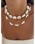 Seashell layered necklace for beach featuring white shell and starfish designs on a model's neck