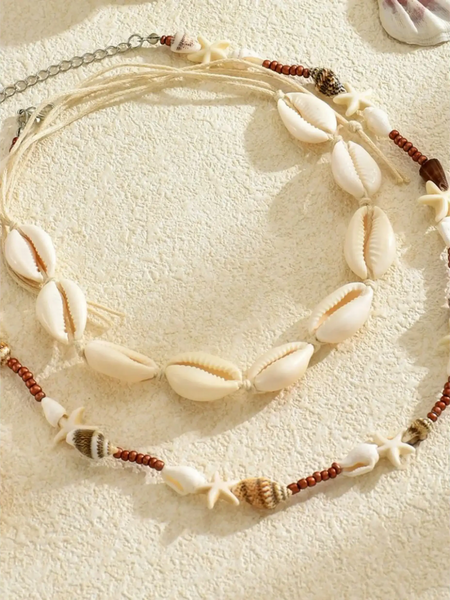 Trendsi seashell layered necklace for beach with natural shells and starfish beads on beige background