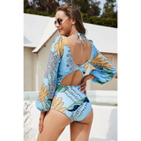 Beach Babes sexty cutout long sleeve swimsuit in blue with floral pattern and back tie detail