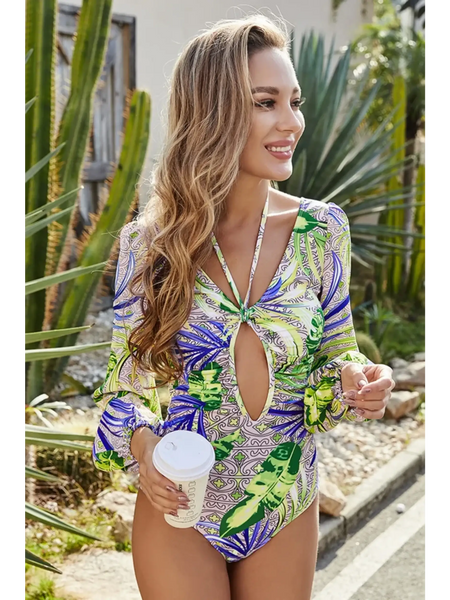 Beach Babes sexty cutout long sleeve swimsuit with tropical green and purple print on woman