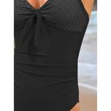 Beach Babes black sexy one-piece bathing suit with textured bust and tie detail at the beach