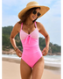 Beach Babes sexy one-piece bathing suit in pink with patterned top worn by woman on the beach