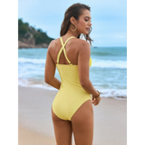 Beach Babes yellow sexy one-piece bathing suit with crisscross back straps on model at the beach