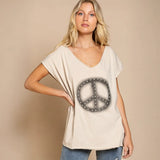 Woman trying on Chic V-neck Beige Tee with peace sign in fitting room
