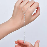 1.3 carat drop necklace with delicate chain and sparkling stones held in hand by Babe Beachwaer
