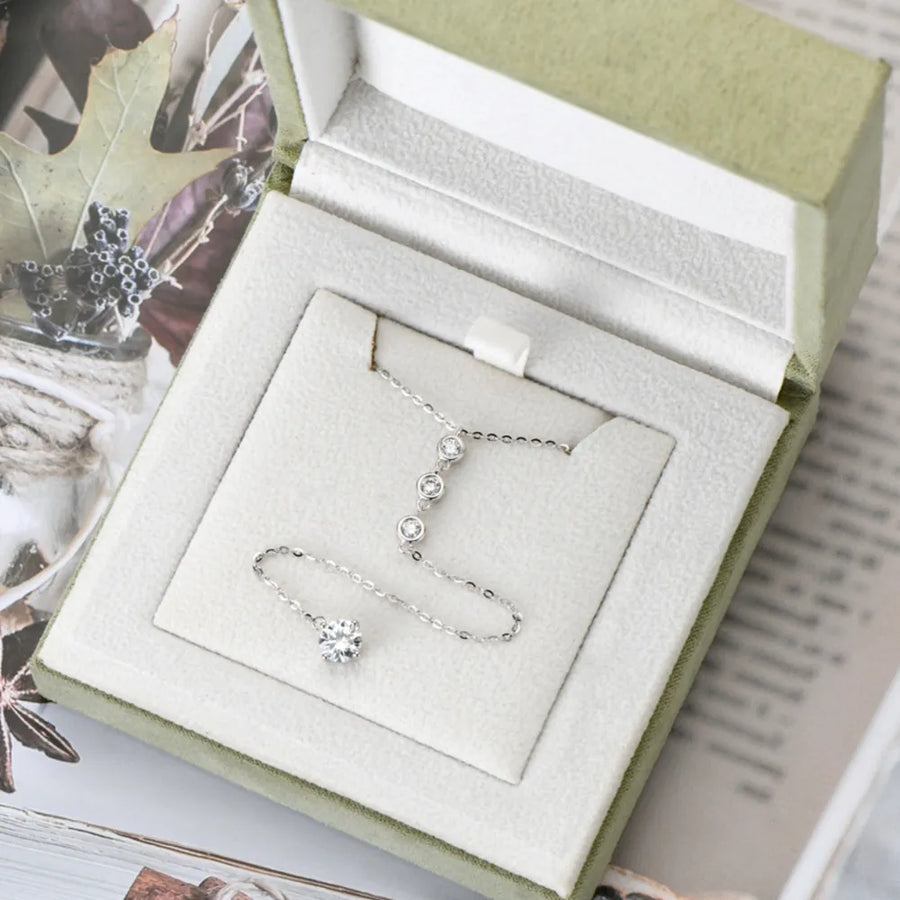 1.3 carat drop necklace with delicate silver chain displayed in a light green jewelry box