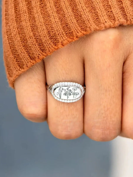  silver women's summer statement ring with floral engraving worn on finger