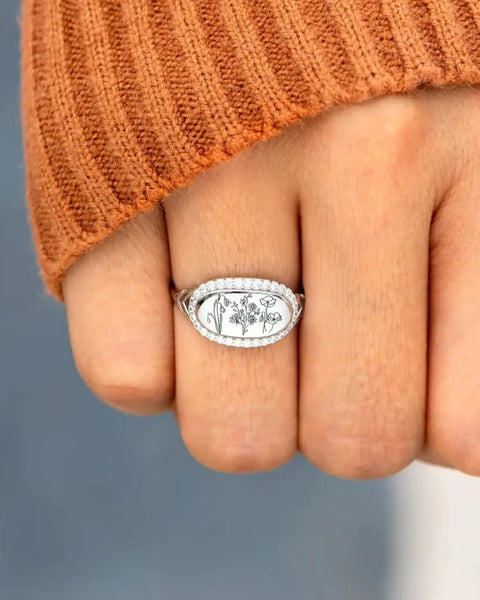  silver women's summer statement ring with floral engraving worn on finger