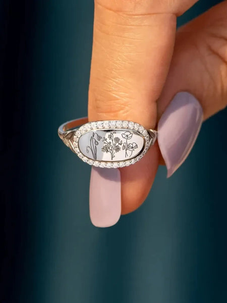 women's summer statement ring with floral design and rhinestone border on silver band