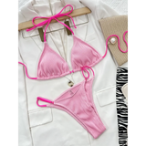 Beach Babes skimpy neon bikini set in bright pink with ribbed texture laid on white blazer
