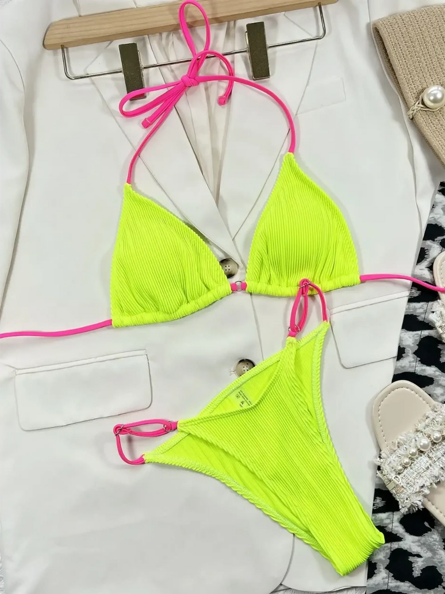 Beach Babes skimpy neon bikini set in bright yellow with pink straps laid on white blazer
