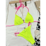 Beach Babes skimpy neon bikini set in bright yellow with pink straps laid on white blazer