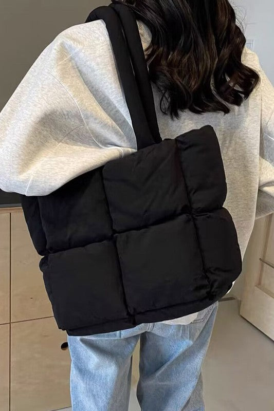 Babe Beachwear small puffer lightweight tote bag in black worn over shoulder with quilted design