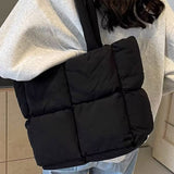 Babe Beachwear small puffer lightweight tote bag in black worn over shoulder with quilted design