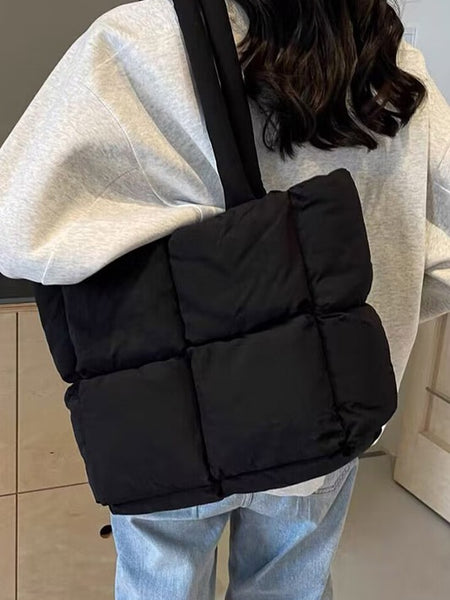 Babe Beachwear small puffer lightweight tote bag in black worn over shoulder with quilted design