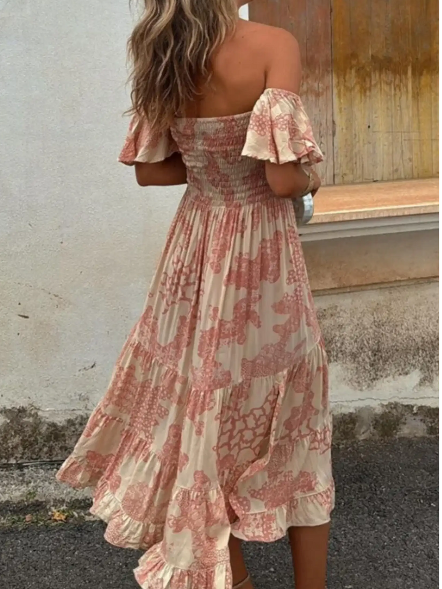Trendsi smocked off shoulder midi dress with pink floral patterns and ruffled hem on model
