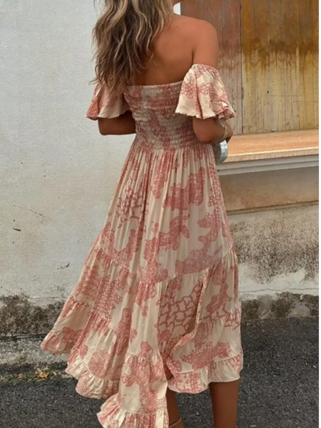 Trendsi smocked off shoulder midi dress with pink floral patterns and ruffled hem on model
