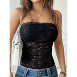 Babe Beachwear black strapless lace crop top worn with blue jeans and white shoulder bag