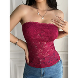 Babe Beachwear strapless lace crop top in red modeled with blue jeans and silver jewelry