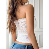 Babe Beachwear strapless lace crop top in white worn with blue jeans showing back view