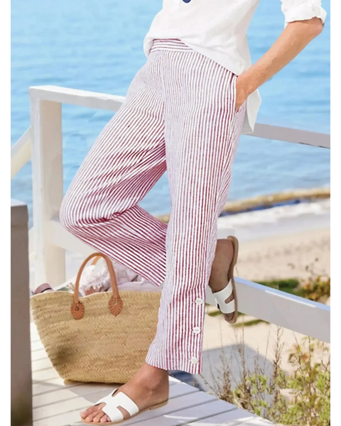 Striped beach pants for women by Babe Beachwear in red and white with side button details