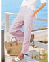 Striped beach pants for women by Babe Beachwear in red and white with side button details