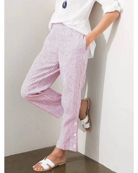 Striped beach pants for women in white and red with side buttons paired with white shirt and sandals