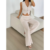 Babe Beachwear striped knit vest and pants set in beige and white worn by model sitting on couch
