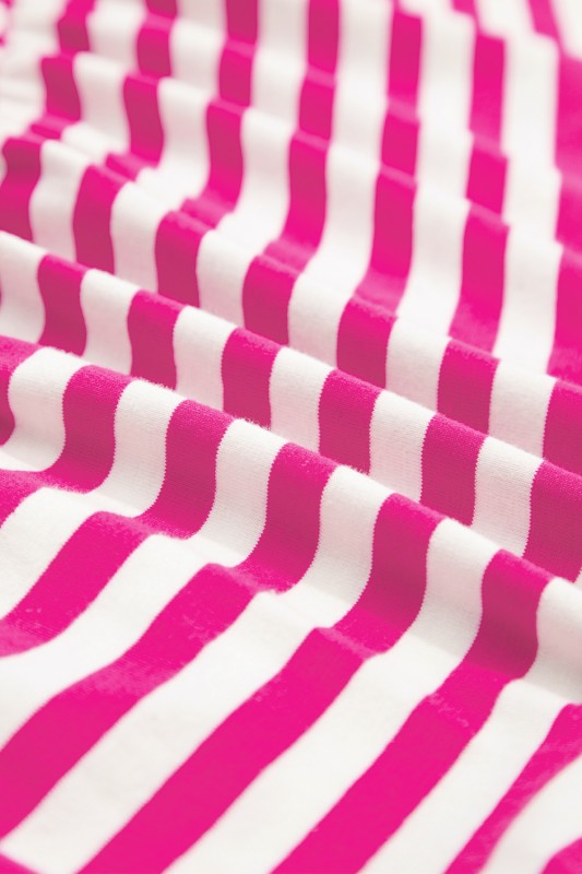 Close-up of EG fashion striped midi dress summer fabric with pink and white stripes